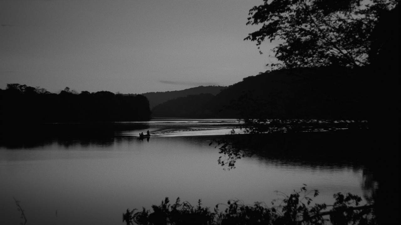 Black and white: Long shot of a boat on a lake